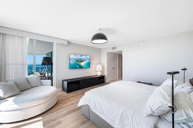 bedroom featuring baseboards, visible vents, access to outside, and light wood-type flooring