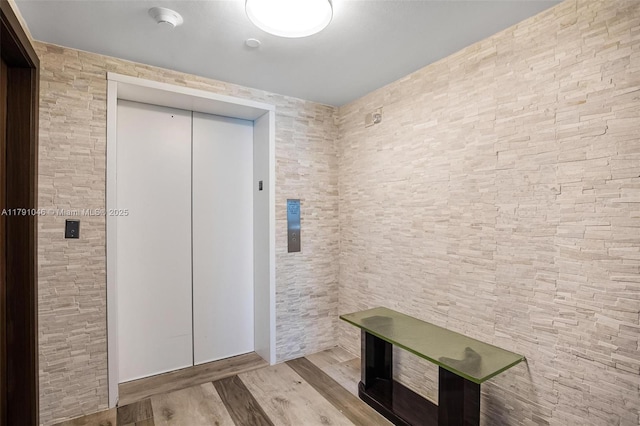 interior space featuring wood finished floors and elevator