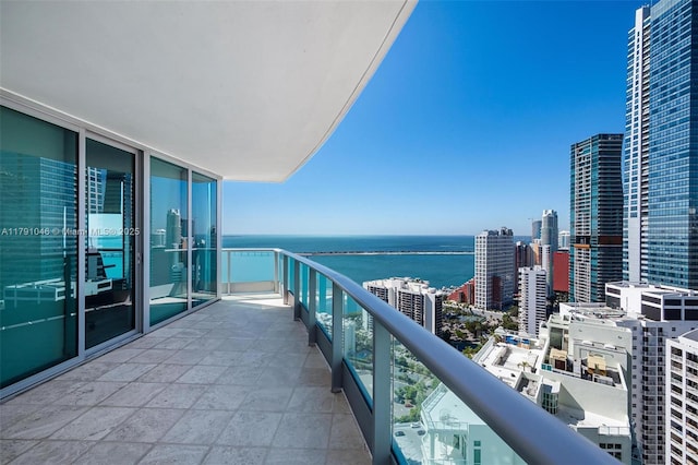 balcony with a water view and a city view