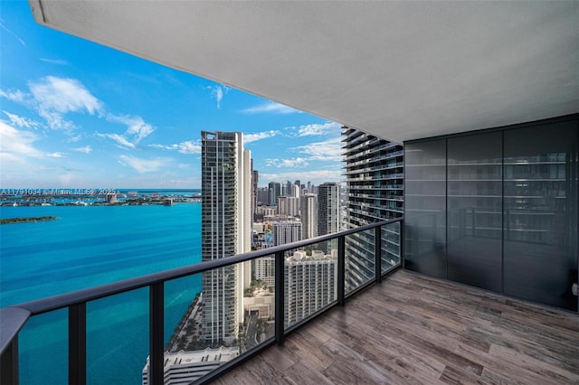 balcony featuring a city view and a water view