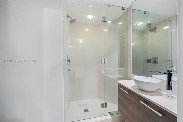 bathroom featuring a stall shower and vanity