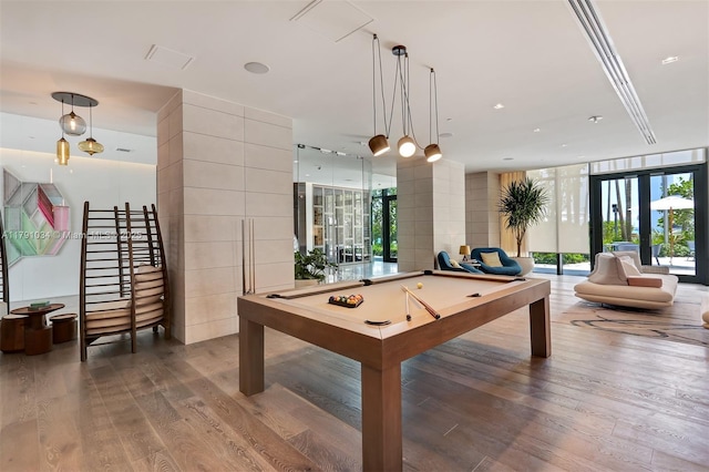 recreation room with dark wood-type flooring, billiards, and a healthy amount of sunlight