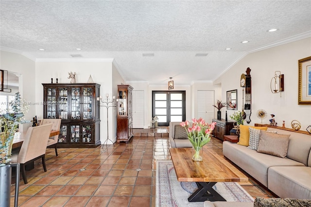 living area with recessed lighting, tile patterned floors, ornamental molding, visible vents, and a textured ceiling