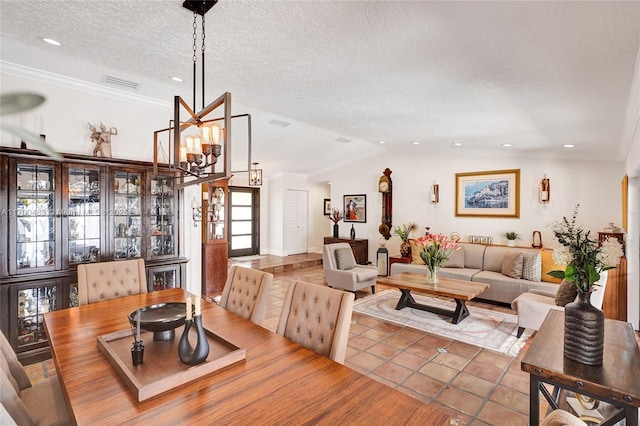 dining area featuring an inviting chandelier, visible vents, vaulted ceiling, a textured ceiling, and tile patterned flooring