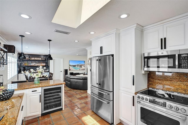 kitchen with recessed lighting, wine cooler, visible vents, appliances with stainless steel finishes, and open floor plan