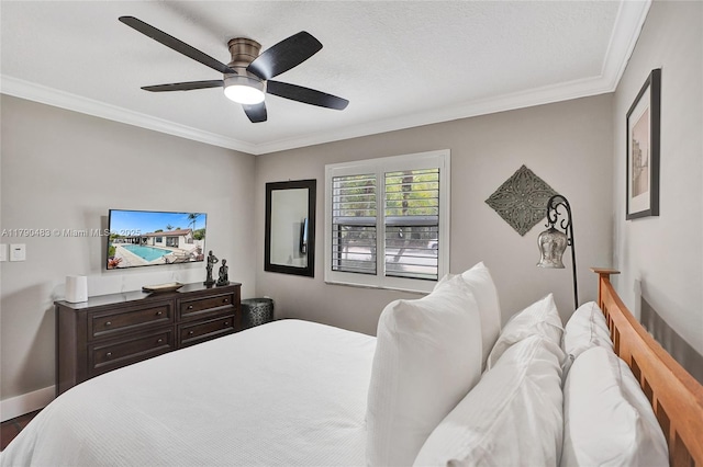 bedroom featuring crown molding, ceiling fan, wood finished floors, and baseboards