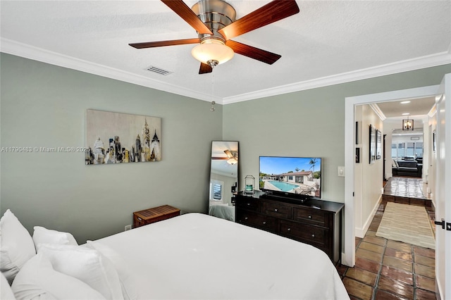 bedroom featuring ceiling fan, crown molding, visible vents, baseboards, and a textured ceiling