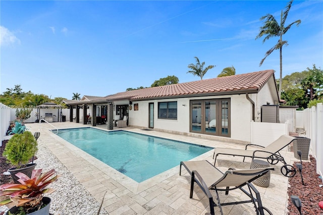 view of pool with a fenced in pool, a fenced backyard, french doors, and a patio area