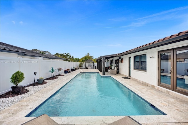 view of swimming pool featuring a fenced backyard, a fenced in pool, and a patio area