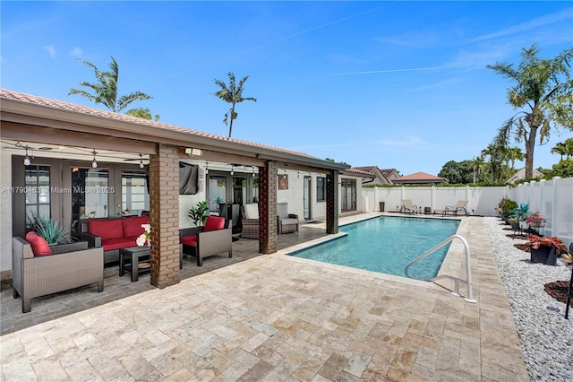 view of pool featuring a patio, a fenced in pool, a fenced backyard, outdoor lounge area, and french doors