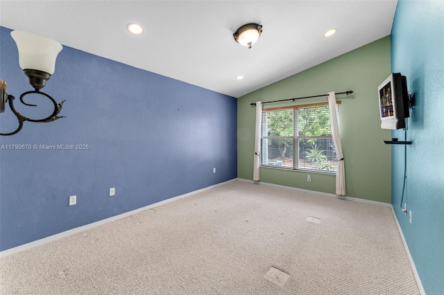 carpeted empty room with recessed lighting, vaulted ceiling, and baseboards