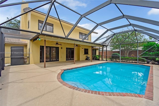 view of swimming pool with fence, ceiling fan, a fenced in pool, a patio area, and french doors