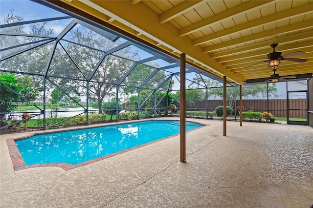 view of swimming pool featuring fence, a fenced in pool, a water view, a patio, and glass enclosure