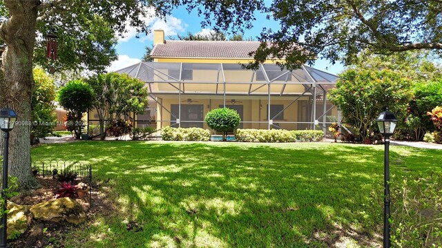 14950 Featherstone Way, Davie, FL 33331 - view of front of house featuring ceiling fan, a front lawn, a chimney, and stucco siding