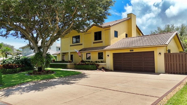 14950 Featherstone Way, Davie, FL 33331 - view of front of property featuring stucco siding, an attached garage, a tile roof, and concrete driveway