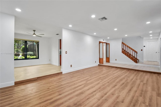 14950 Featherstone Way, Davie, FL 33331 - unfurnished living room with light wood-style floors, recessed lighting, ceiling fan, baseboards, and stairs