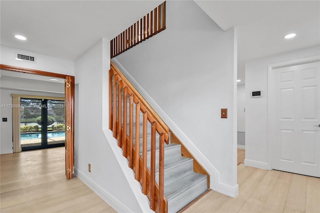 stairway with visible vents, recessed lighting, baseboards, and wood finished floors