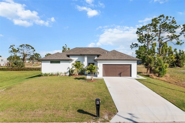 view of front of house featuring a garage, a front lawn, driveway, and stucco siding