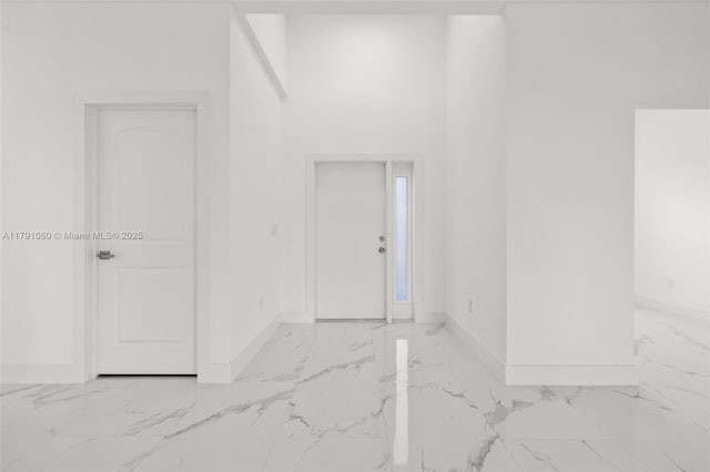 empty room with marble finish floor and baseboards
