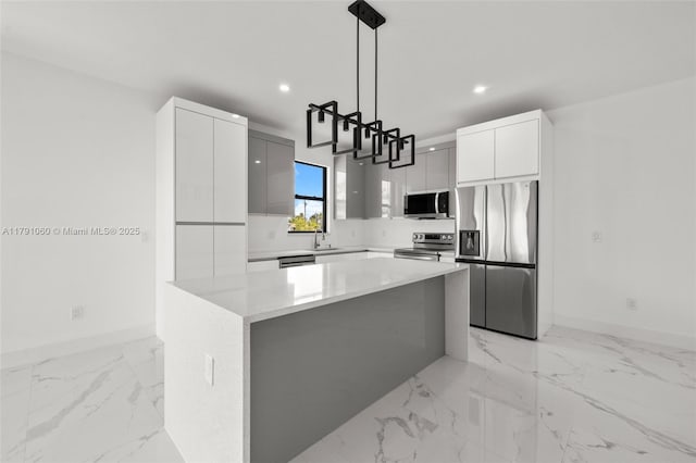kitchen featuring recessed lighting, modern cabinets, appliances with stainless steel finishes, and baseboards