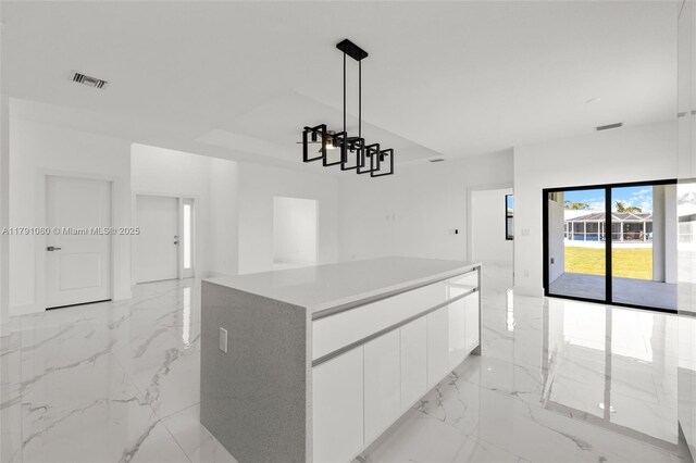 kitchen featuring white cabinets, visible vents, open floor plan, modern cabinets, and marble finish floor