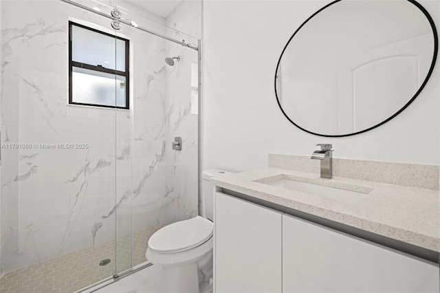 full bathroom with toilet, a marble finish shower, and vanity