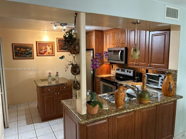 9040 SW 125th Ave Unit D105, Miami, FL 33186 - kitchen featuring decorative backsplash, dark stone counters, appliances with stainless steel finishes, visible vents, and a peninsula