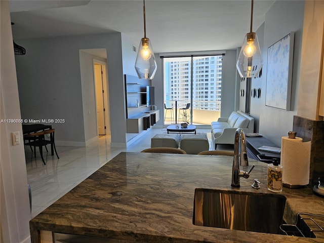 interior space with baseboards and marble finish floor