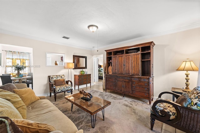 living area featuring visible vents, ornamental molding, and baseboards