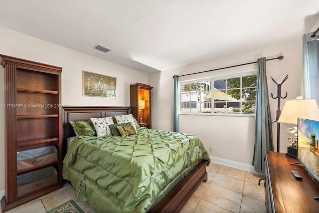 bedroom with baseboards and visible vents