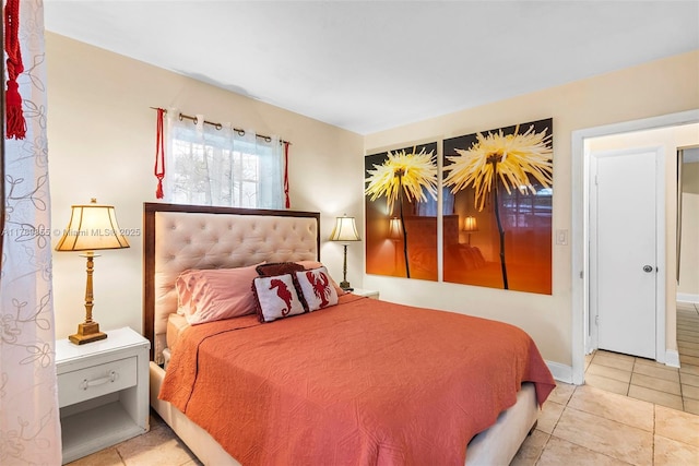 tiled bedroom featuring baseboards