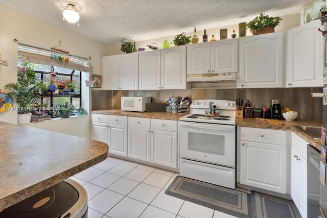 kitchen featuring white cabinets, white appliances, a textured ceiling, and under cabinet range hood