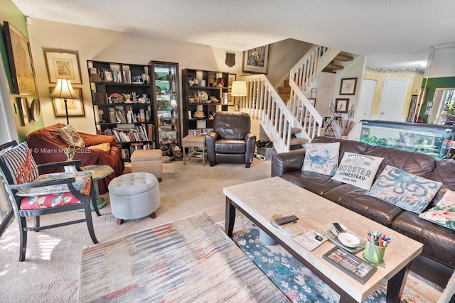 living area featuring stairway and carpet