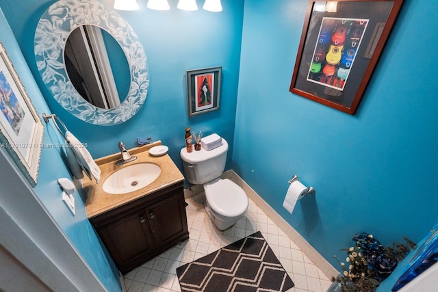 bathroom with tile patterned floors, baseboards, toilet, and vanity