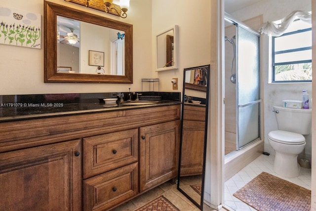 full bath featuring toilet, tile patterned flooring, a shower stall, and vanity