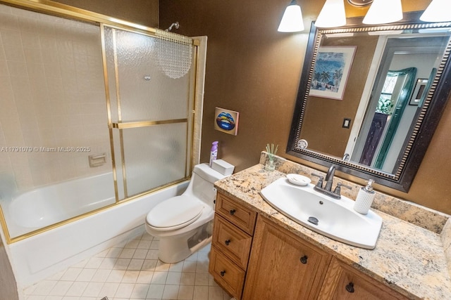 full bath with tile patterned floors, shower / bath combination with glass door, toilet, and vanity