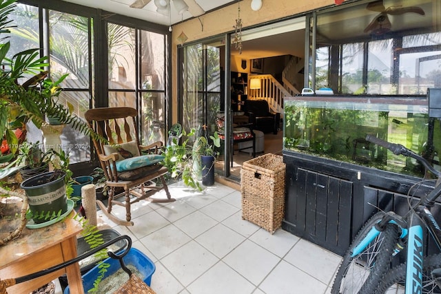 sunroom featuring a ceiling fan