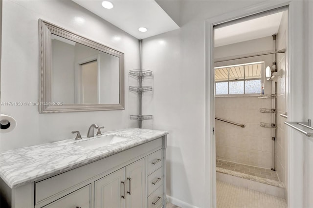 bathroom with vanity, recessed lighting, and tiled shower