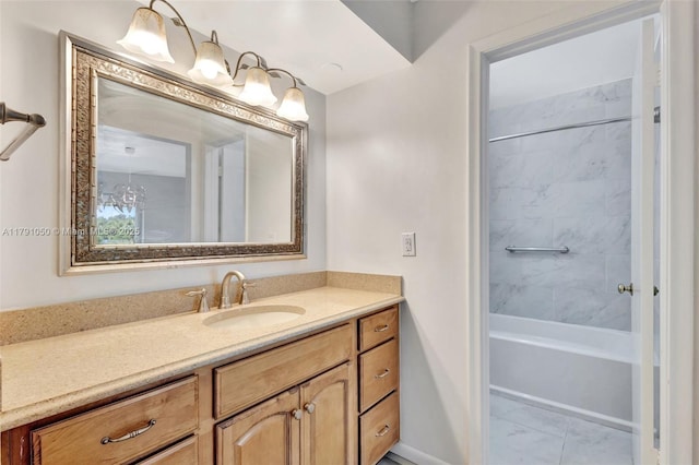 bathroom featuring vanity, baseboards, and shower / bathing tub combination