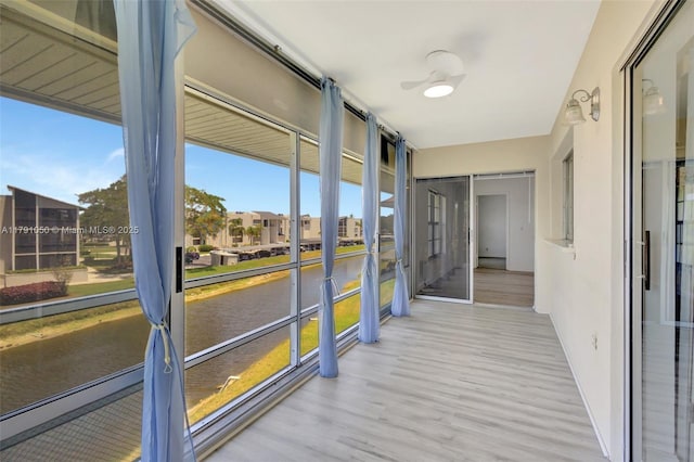 unfurnished sunroom with a water view