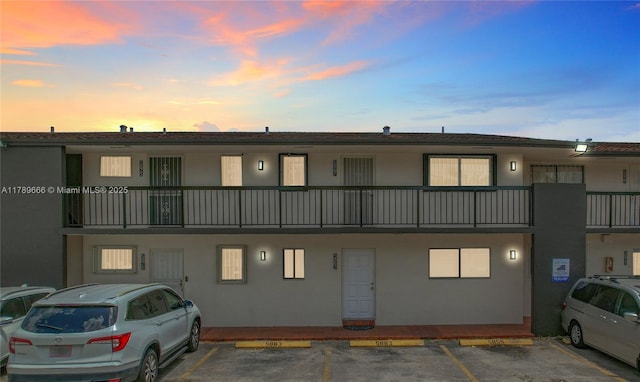 view of property featuring uncovered parking