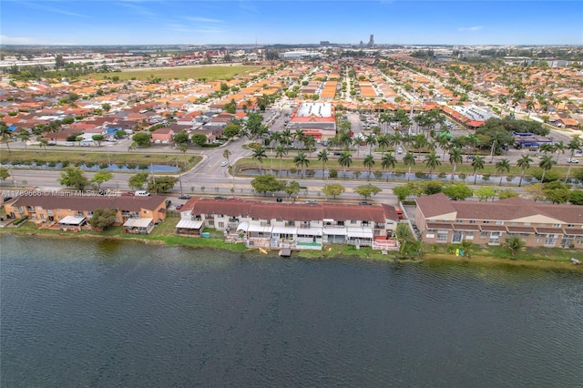 aerial view of property's location featuring nearby suburban area and a nearby body of water