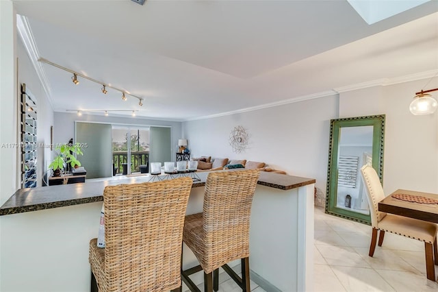 800 NE 195th St Unit 518, Miami, FL 33179 - dining room with rail lighting, ornamental molding, light tile patterned floors, and a skylight