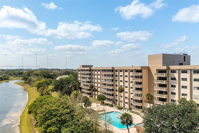 view of property featuring a community pool and a water view