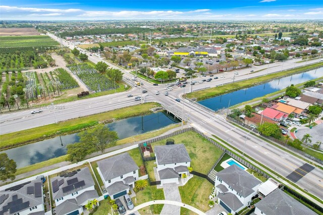 bird's eye view featuring a water view and a residential view