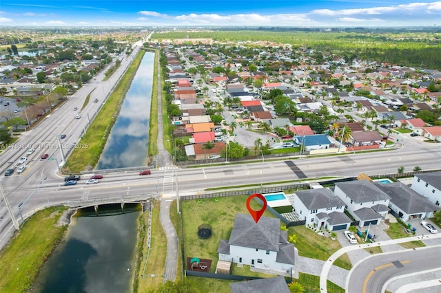 bird's eye view featuring a water view and a residential view