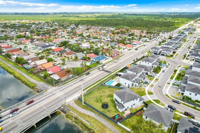 birds eye view of property with a residential view and a water view