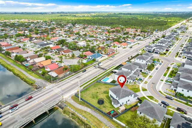 drone / aerial view with a water view and a residential view
