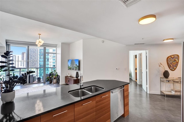 kitchen with stainless steel dishwasher, brown cabinetry, dark countertops, a sink, and modern cabinets