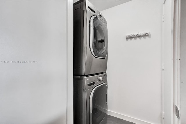 laundry area featuring stacked washing maching and dryer and laundry area